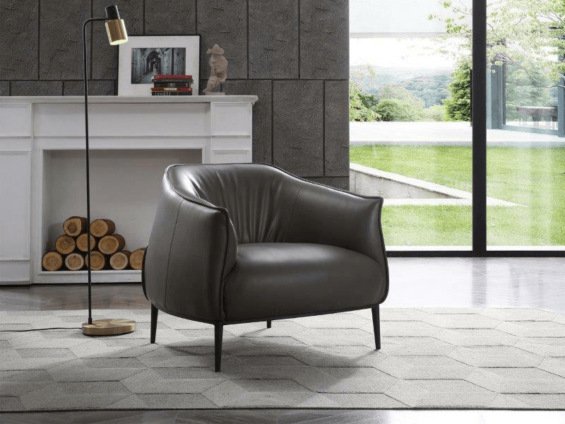 dark gray lounge chair in front of a faux fireplace