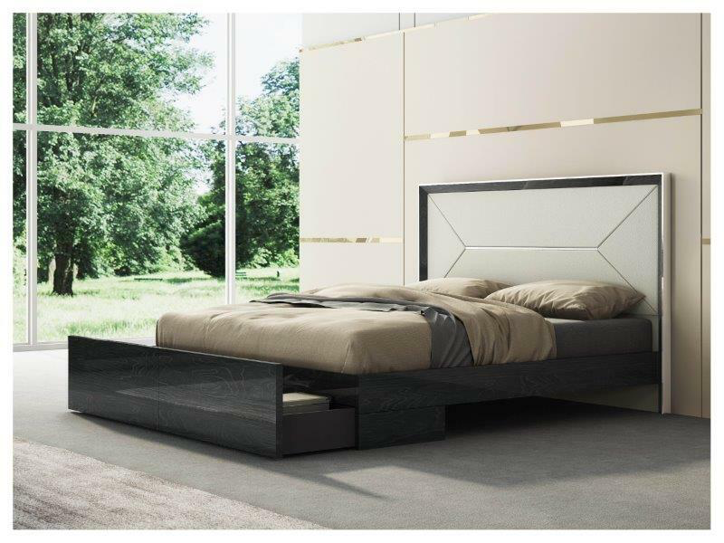 white and black king bed against a tan and gold wall